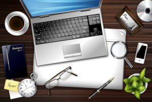 Laptop with eyeglass pens and watch